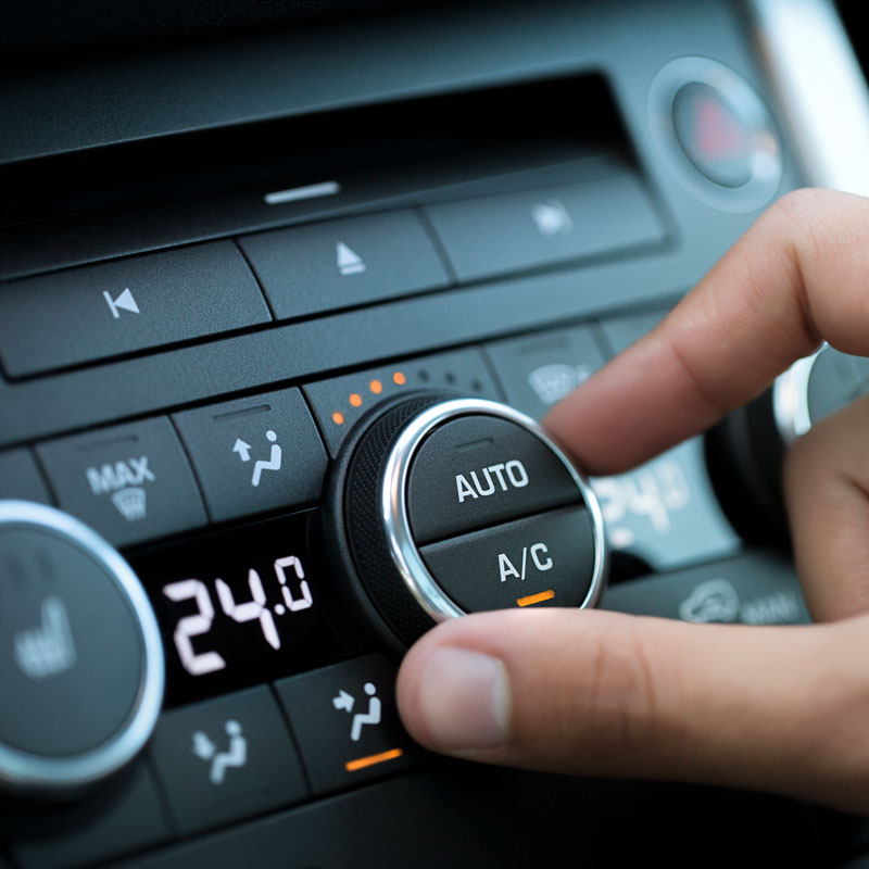 hand on ac knob in car
